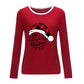 Red long sleeve shirt with white collar trim featuring a plaid Santa hat and holiday message, perfect for Christmas celebrations.